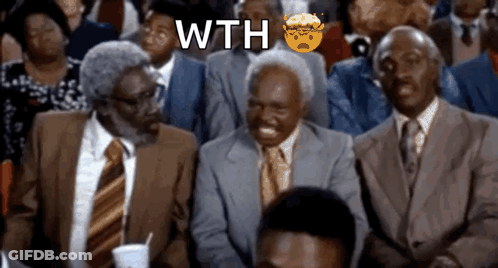 A Group Of Men In Suits And Ties Are Sitting In A Crowd With The Word Wth Written Above Them GIF