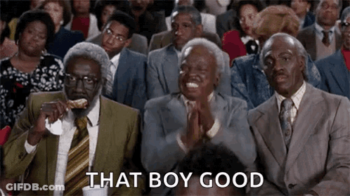 A Group Of Men In Suits And Ties Are Sitting In A Row Clapping . GIF