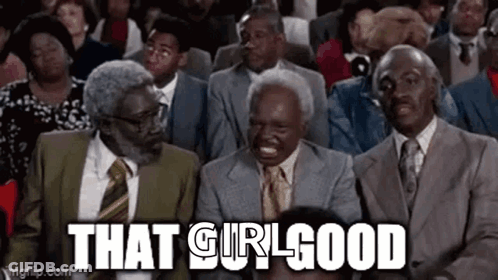 A Group Of Men In Suits And Ties Are Sitting In A Row Laughing . GIF