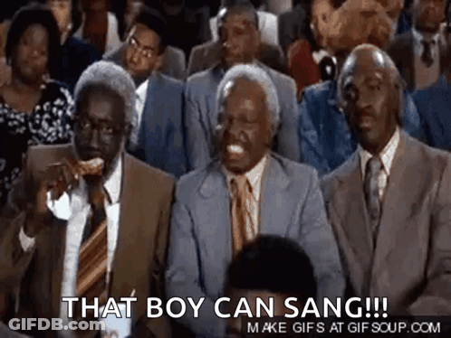 A Group Of Men In Suits And Ties Are Sitting In A Stadium . GIF
