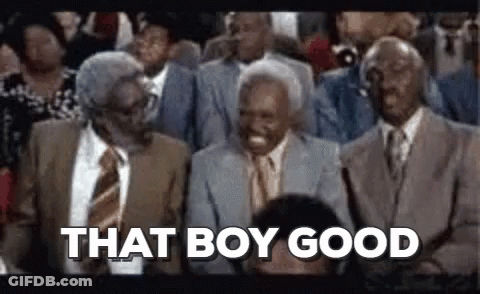 A Group Of Men In Suits And Ties Are Sitting In A Stadium . GIF