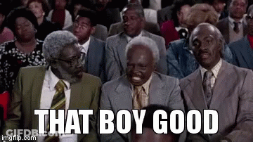 A Group Of Men In Suits And Ties Are Sitting In A Theatre . GIF