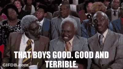 A Group Of Men In Suits And Ties Are Sitting In A Theatre . GIF