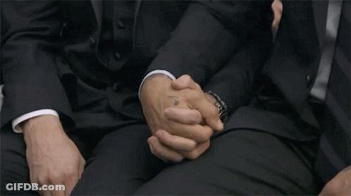 Men In Suits Sitting And Holding Hands GIF
