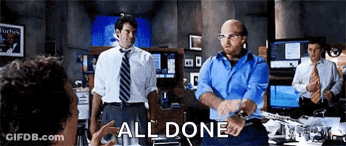A Group Of Men In Suits And Ties Are Standing In A Room With The Words All Done Written On The Screen . GIF
