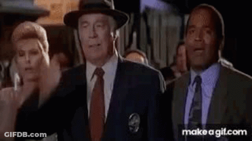 A Group Of Men In Suits And Ties Are Standing Next To Each Other In A Room . GIF