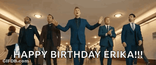 A Group Of Men In Suits And Ties Are Walking Down A Hallway And Singing Happy Birthday Erika GIF