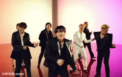 A Group Of Men In Suits Are Dancing Together On A Red Floor GIF