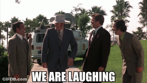 A Group Of Men In Suits Are Laughing In Front Of A Van With The Number 9 On The Back GIF