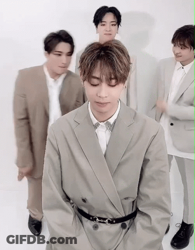 A Group Of Men In Suits Are Posing For A Picture . GIF