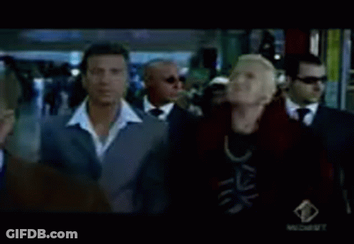 A Group Of Men In Suits Are Standing In Front Of A Window .. GIF