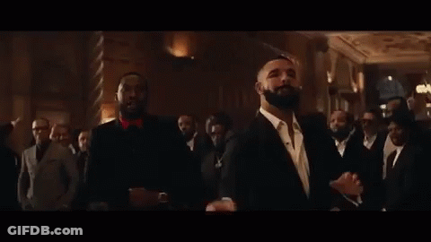 A Group Of Men In Suits Are Standing Next To Each Other In A Room . GIF