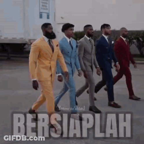 A Group Of Men In Suits Are Walking In A Line . GIF