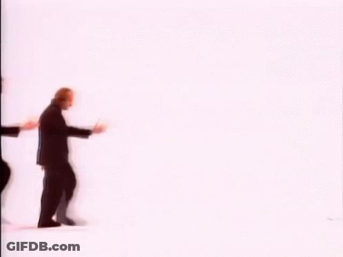 A Group Of Men In Suits Are Walking In A Row . GIF