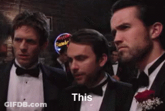 A Group Of Men In Tuxedos And Bow Ties Are Standing Next To Each Other In A Bar . GIF