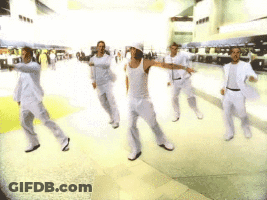 A Group Of Men In White Clothes Are Dancing In A Room GIF