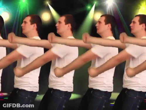 A Group Of Men In White Shirts Are Dancing In A Line GIF
