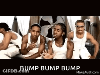 A Group Of Men In White Tank Tops Are Standing Next To Each Other . GIF