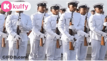 A Group Of Men In White Uniforms Are Standing In A Line With Their Guns .. GIF