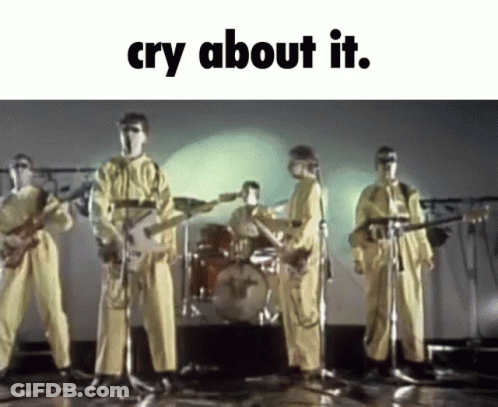 A Group Of Men In Yellow Jumpsuits Are Playing Guitars And Singing Into Microphones With The Words Cry About It Below Th GIF