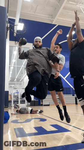 A Group Of Men Playing Basketball On A Court With The Letter L On The Floor GIF