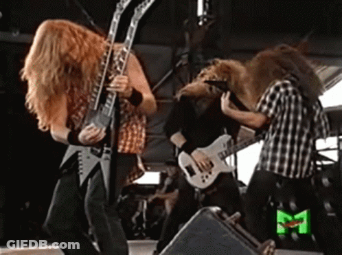 A Group Of Men Playing Guitars On A Stage With A Green M On The Bottom Right GIF