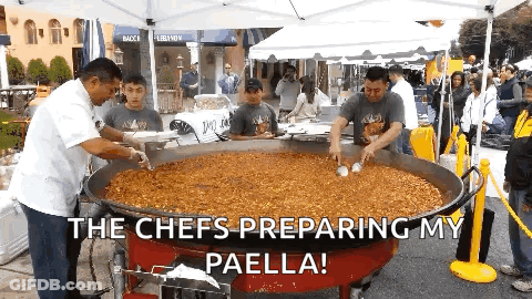 A Group Of Men Preparing Paella In A Large Pan With The Caption The Chefs Preparing My Paella GIF
