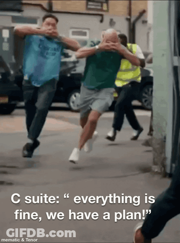 A Group Of Men Running Down A Street With The Words " C Suite Everything Is Fine We Have A Plan " GIF
