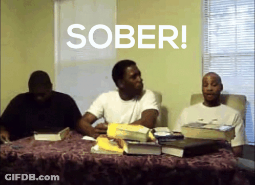 A Group Of Men Sit At A Table With The Word Sober Written On The Screen GIF