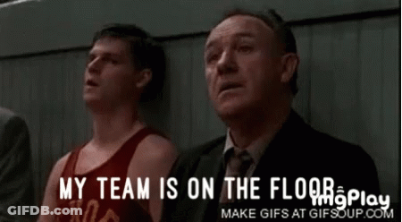 A Group Of Men Sitting In A Stadium With The Words My Team Is On The Floor GIF