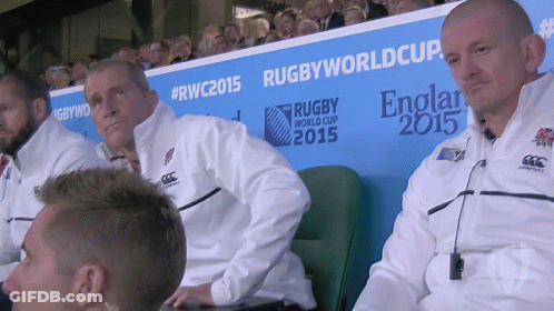 A Group Of Men Sitting In Front Of A Rugby World Cup 2015 Sign GIF