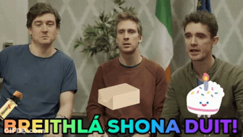 A Group Of Men Sitting Next To Each Other With The Words Breithla Shona Duit GIF