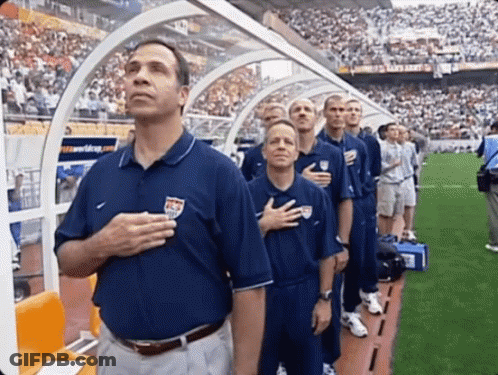 A Group Of Men Stand With Their Hands On Their Hearts GIF