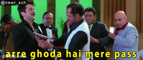A Group Of Men Standing Around A Man Holding A Gun With The Caption Arre Ghoda Hai Mere Pass GIF