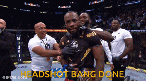 A Group Of Men Standing Around A Man With The Words Headshot Bang Done Written On The Bottom GIF