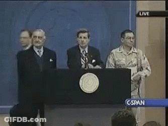 A Group Of Men Standing Behind A Podium With A Live Sign Above Them GIF
