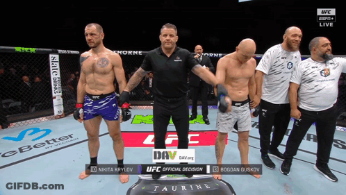 A Group Of Men Standing In A Boxing Ring With The Words Ufc Official Decision On The Screen GIF