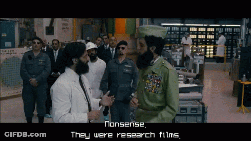 Men Standing In Room With Nonsense Research Films Sign GIF