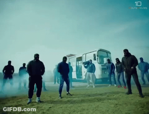 A Group Of Men Standing In Front Of A Bus With The Number 10 On The Bottom Right GIF