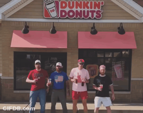 A Group Of Men Standing In Front Of A Dunkin Donuts GIF