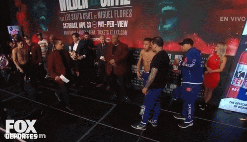 A Group Of Men Standing In Front Of A Fox Deportes Sign GIF