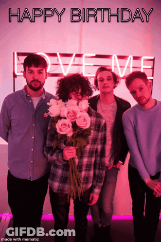 A Group Of Men Standing In Front Of A Love Me Sign GIF