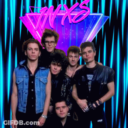 A Group Of Men Standing In Front Of A Neon Sign That Says Nyx GIF