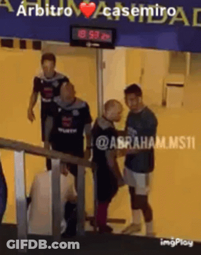 A Group Of Men Standing In Front Of A Sign That Says Arbitro GIF