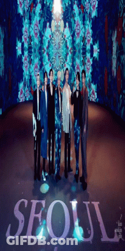 A Group Of Men Standing In Front Of A Sign That Says Seoul On It GIF