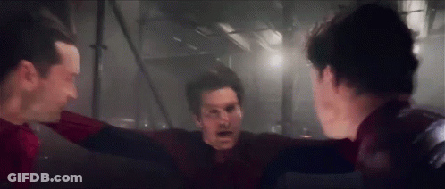 A Group Of Men Standing Next To Each Other In A Dark Room . GIF