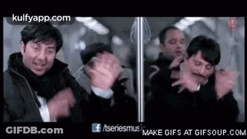 A Group Of Men Standing Next To Each Other On A Train . GIF