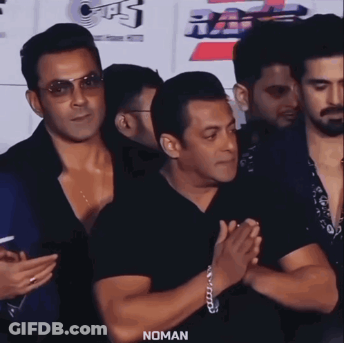 A Group Of Men Standing Next To Each Other With The Word Noman On The Bottom Left GIF