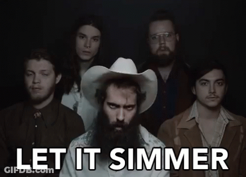 A Group Of Men Standing Next To Each Other With The Words Let It Simmer Written Above Them GIF
