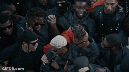 A Group Of Men Wearing Black Jackets And Sunglasses Are Standing Together GIF